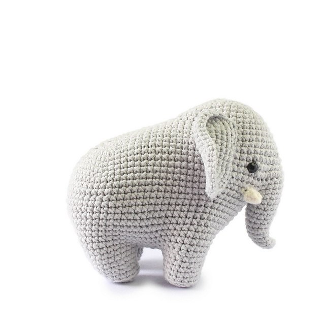 Crochet elephant toy on a white background, highlighting its detailed design and handmade texture.