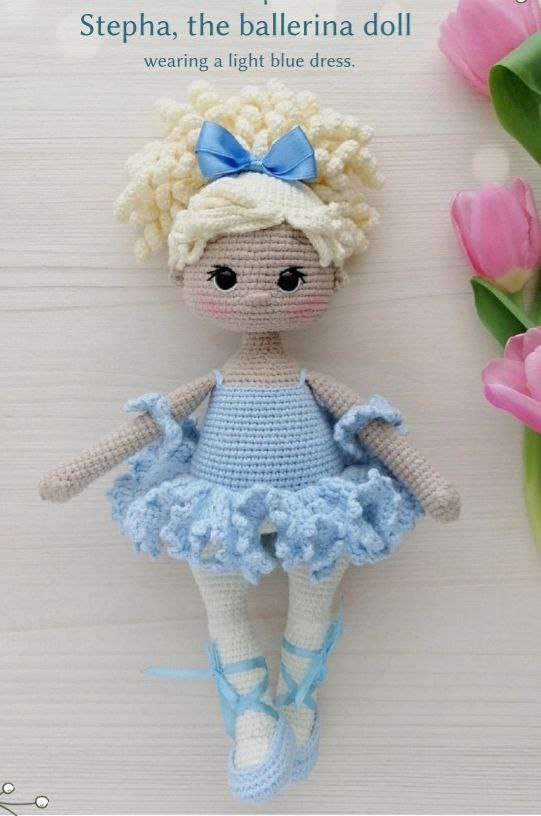 Crochet ballerina doll with blue hair and blue dress, showcasing a charming and colorful design.