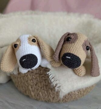 Two dogs in a basket next to a crochet design, set against a colorful background.